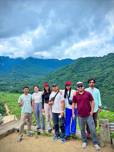 Group photograph overlooking green mountains